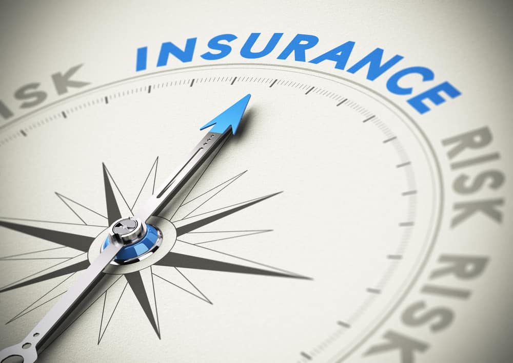Compass needle pointing the word insurance. Concept image blue and beige tones
