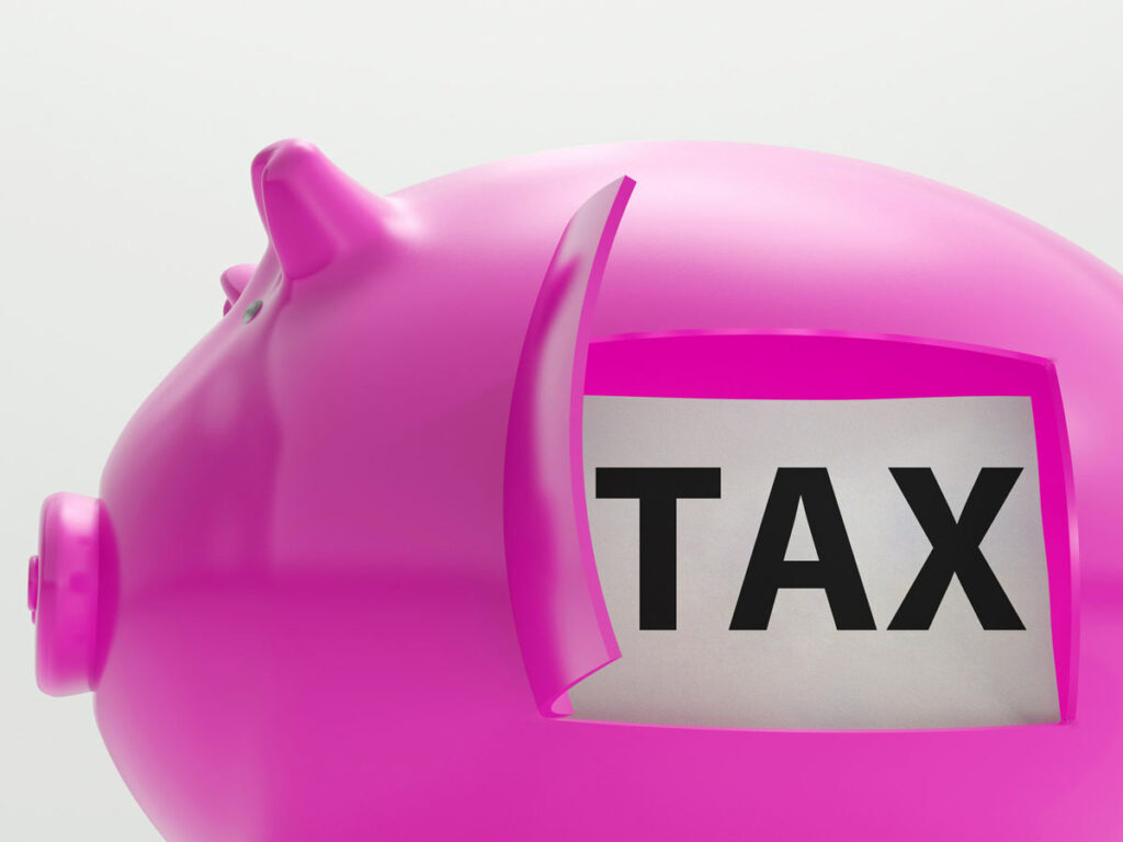 An independent contractor's piggy bank with an opening in the side revealing the word TAX indicating tax savings. 