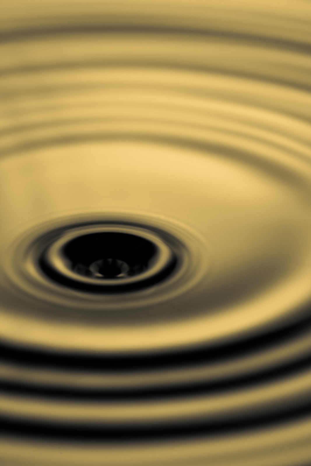 Water ripple with a yellowish hue on the water.