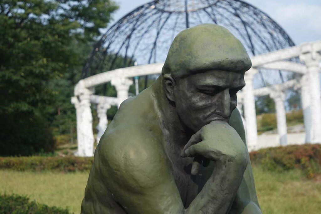 The statue of the Thinker, who is obviously thinking about the factors that make up how much Uber Eats pays.