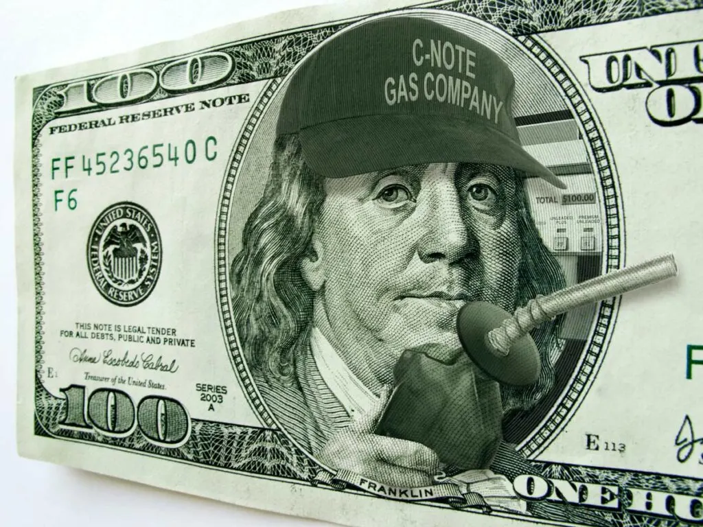A $100 bill with Ben Franklin holding a gas nozzle and a gas pump behind him showing $100.00 as the price.