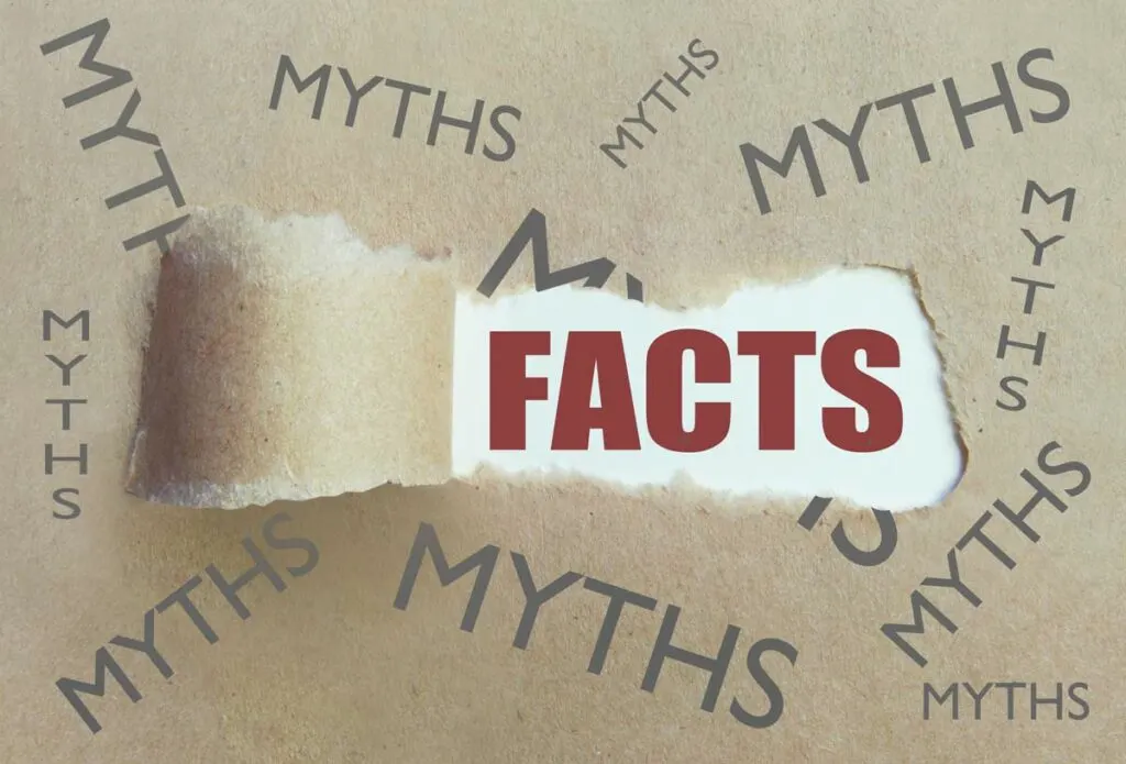 Facts surrounded by myths concept illustrated by brown paper, with the word Myths printed several times and a section torn away to reveal the word Facts.