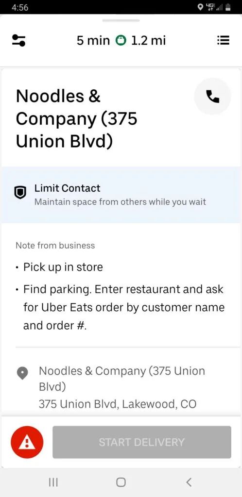 Screenshot of Uber Eats order screen after swiping up from address field that reveals restaurant information, pickup instructions, and a red and white warning triangle next to the start delivery button.
