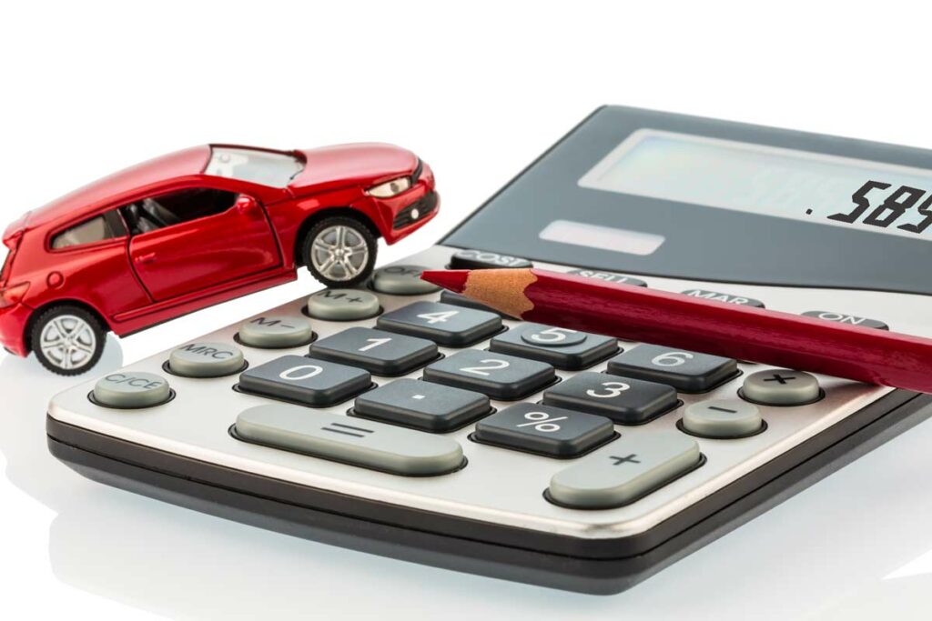 The 2022 Standard Mileage Allowance rate of .585 per mile displayed on a calculator with a model car illustrating the cost of driving.