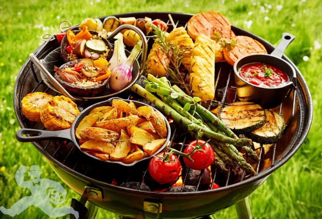 A large barbeque grill with a lot of food on it which is food not being delivered by Doordash.