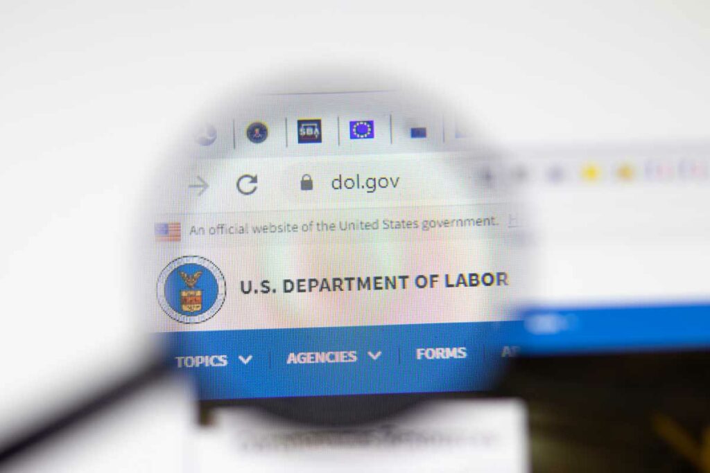 A view that looks to be through a magnifying glass of the U.S. Department of Labor home page at dol.gov.
