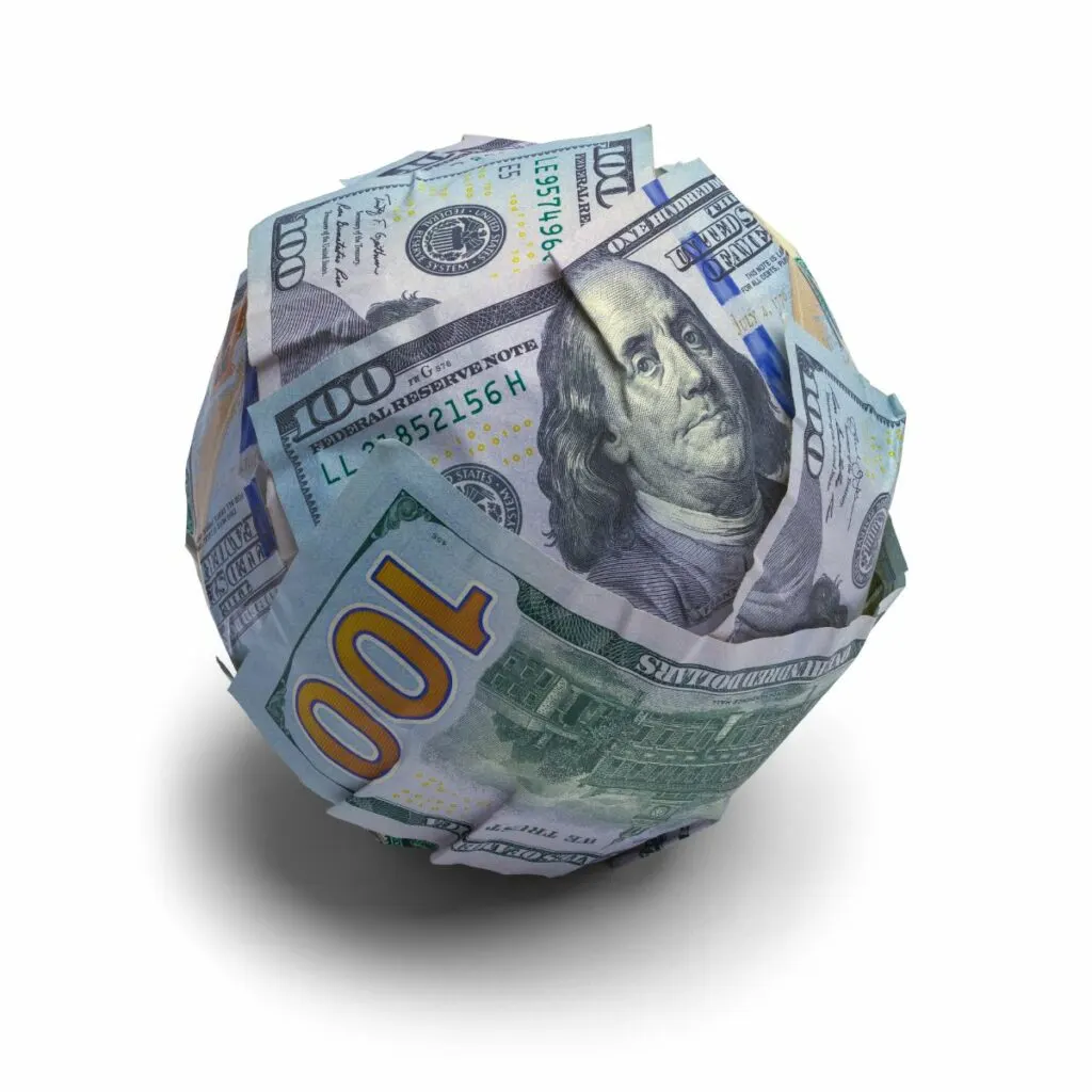 A debt snowball illustrated by a bunch of $100 bills rolled up into a ball.